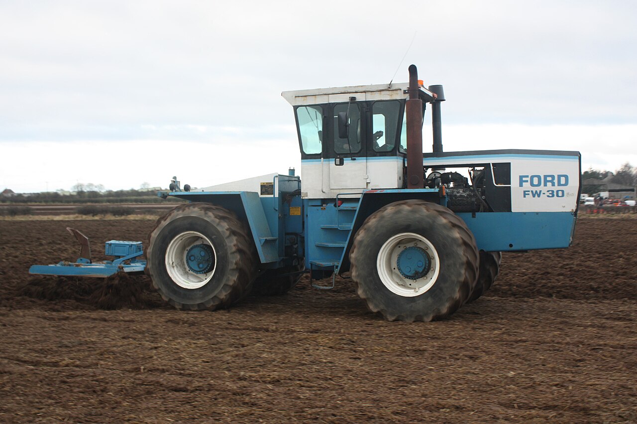 Tractor pulling a subsoiler for deep soil loosening without turning