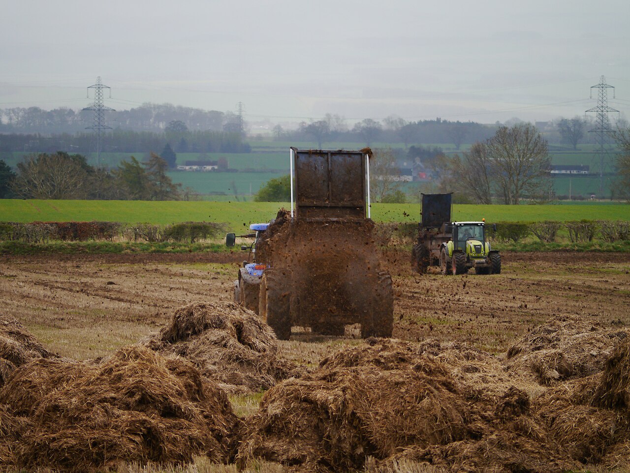 Spreading farmyard manure over the field — input of organic matter