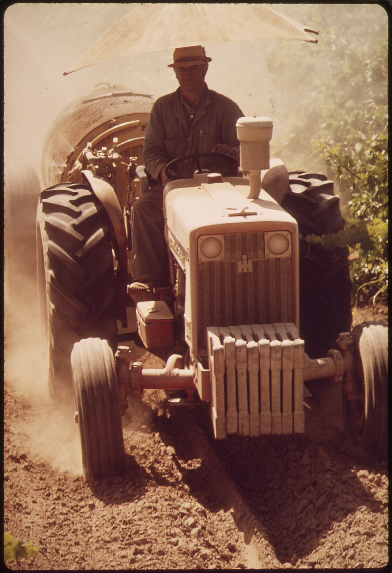 Operator on a tractor during orchard spraying