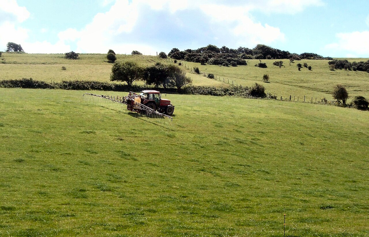 Tractor-mounted sprayer with wings spread for plant protection product application