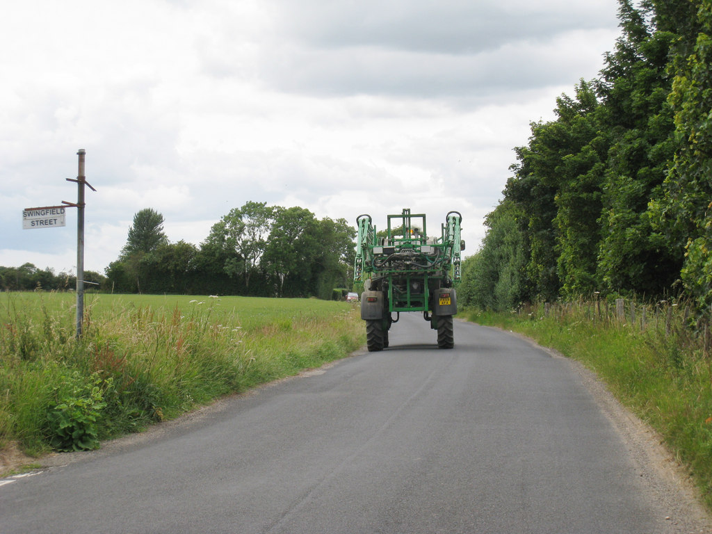 Sprayer for plant protection product application with wings folded on a rural road