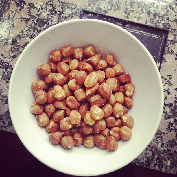 white bowl of roasted hazelnuts