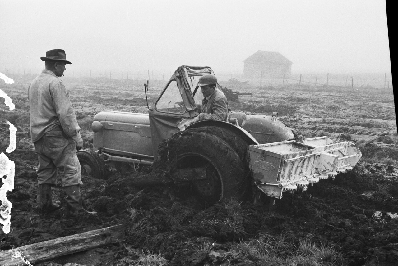 Tractor with mineral fertilizer spreader on field