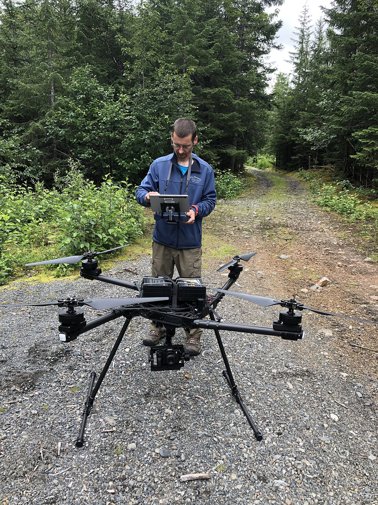 farmer operating drone in orchard